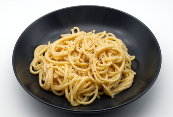 Spaghetti cacio e pepe isolated on white background.