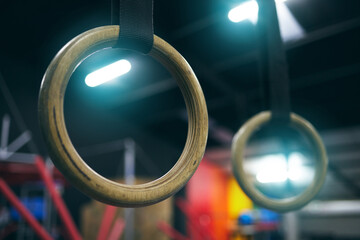 Gymnastics ring, training and equipment in an empty gym for olympics preparation closeup from below. Exercise, health and interior with sports rings in a fitness center for an olympic workout