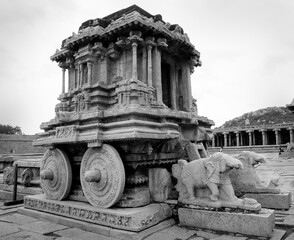 Stone chariot of Vijayavitthala temple in Hampi. Monochrome shot of Unesco heritage site in...