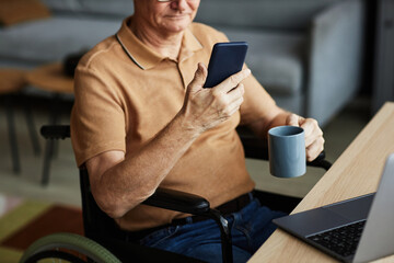 Senior man with disability using smartphone