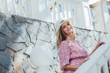 beautiful blonde in a glab walk on the street