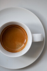 Espresso in a white cup, white background