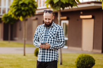 A young man walks in the park.