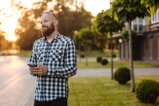 A young man walks in the park.