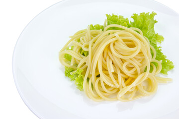 spaghetti with lettuce on white dish isolated