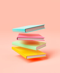 Stack of colorful books against pink background