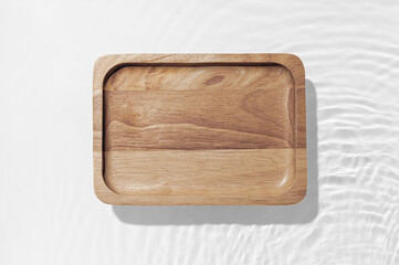 Wooden plate on the water surface background. Flat lay, copy space.	