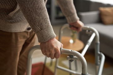 Elderly man walking with the help of walker