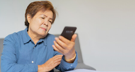 close up mature woman holding smartphone and checking news , people and technology concept