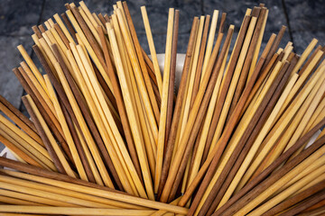 A bucket full of clean wooden chopsticks at a street stall in Hanoi Vietnam.