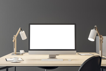 Front view on blank white modern computer monitor with space for your logo or text on wooden work table with lamps on grey wall background. 3D rendering, mock up