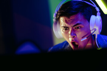 Gasping gamer expressing his shock as he sits in front of his gaming pc © Jacob Lund