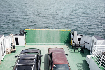 Fototapeta na wymiar motor ship ferry with two cars at sea