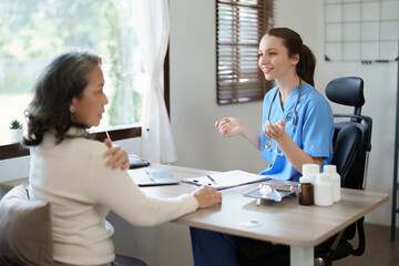 Portrait of a female doctor discuss to a patient with shoulder pain.