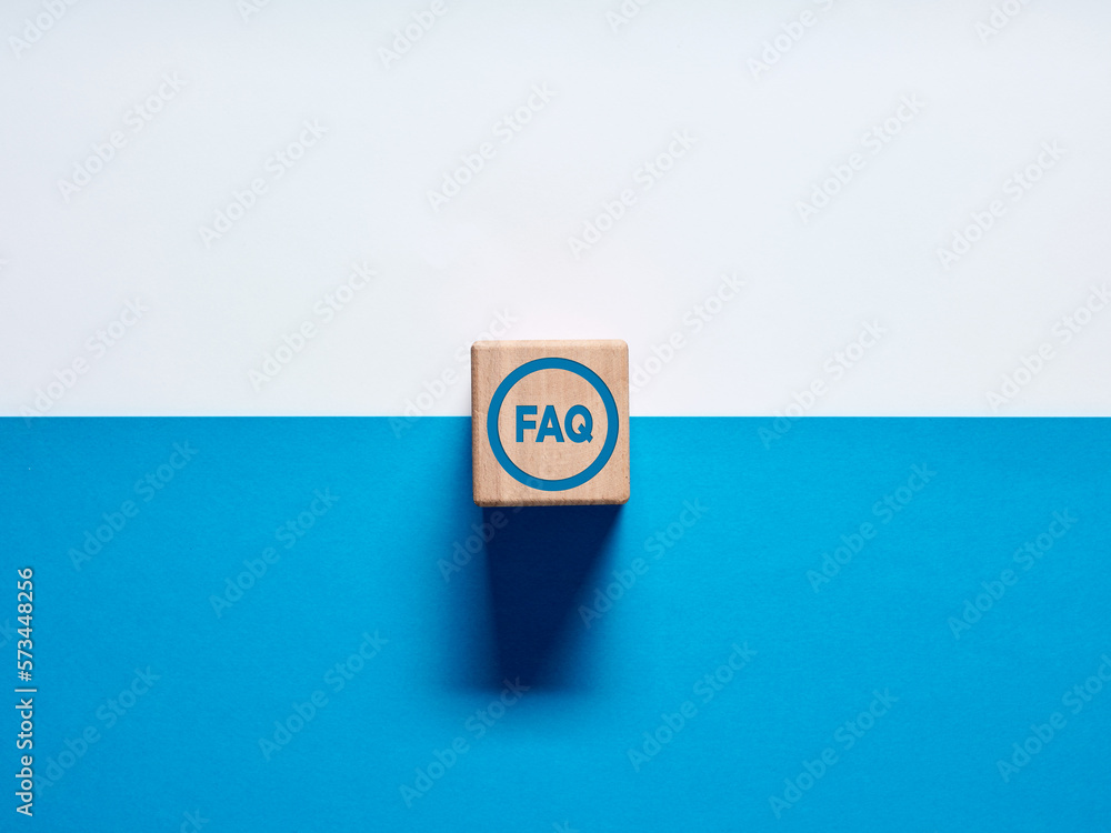 Poster the acronym faq frequently asked questions on wooden cube push button on blue and white background.