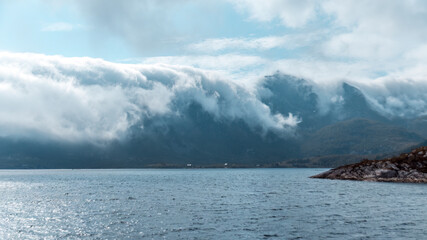 Fototapeta na wymiar Fog rolling over Mountain Peaks in the Lofoten Archipelago (Norway)