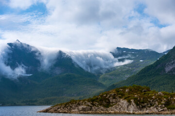 Fog rolling over Mountain Peaks in the Lofoten Archipelago (Norway)