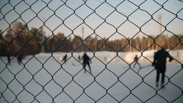 Children play bandy on the hockey rink. An exciting game with passion. Slow motion.