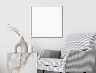 Empty square frame mockup in modern minimalist interior with plant in trendy vase and chair on white wall background, Template for artwork, painting, photo or poster, Real photograph
