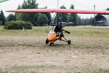 paraglider with motor is standing on ground