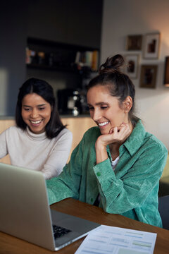 Happy freelancers working on laptop at desk