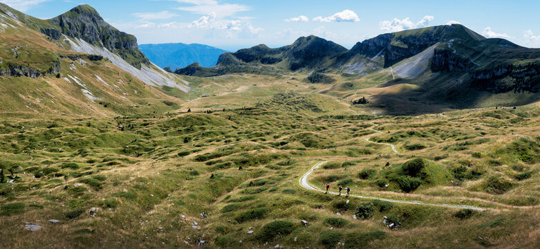 Man and women hiking towards Rifugio dal piaz at Dolomites, Italy