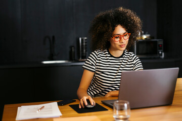 Freelancer working on laptop at table