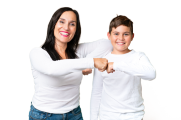 Little caucasian kid over isolated chroma key background bumping fists