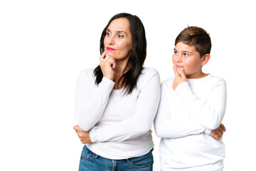 Little caucasian kid over isolated chroma key background looking to the side