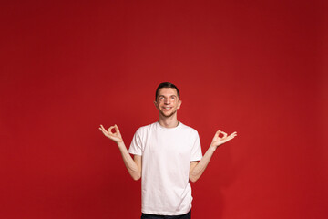 Banner showing a young man meditating with a smile, advertising yoga and meditation classes