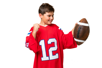 Little caucasian kid playing rugby over isolated chroma key background celebrating a victory