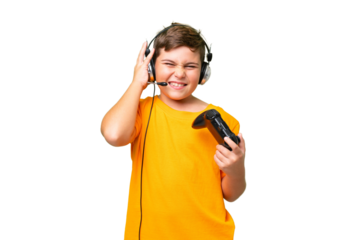 Little caucasian kid playing with a video game controller over isolated chroma key background frustrated and covering ears