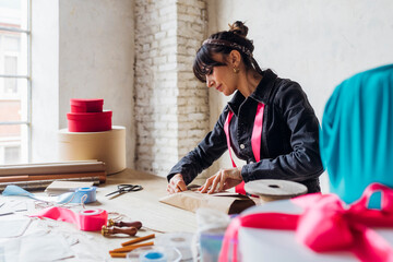 Woman wrapping gift with paper