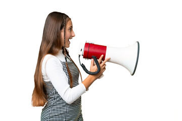 Young girl over isolated chroma key background shouting through a megaphone