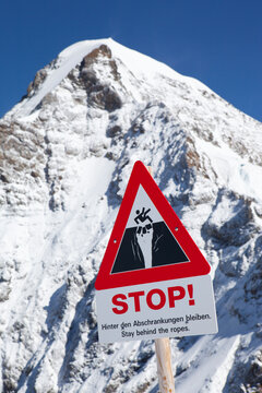 Sign warning for steep cliffs at Jungfraujoch in Swiss Alps, Grindelwald, Bernese Oberland, Bern Canton, Switzerland
