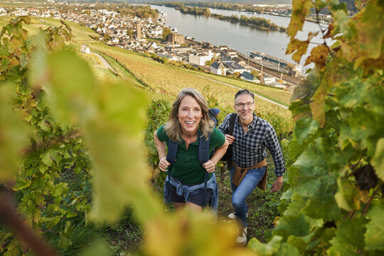 Happy woman hiking with man on hill