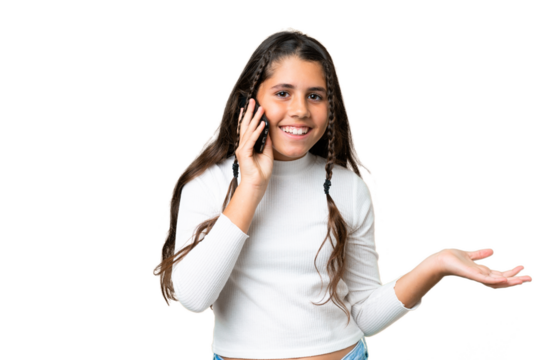 Young girl over isolated chroma key background keeping a conversation with the mobile phone with someone