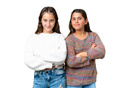 Friends girls over isolated chroma key background keeping the arms crossed