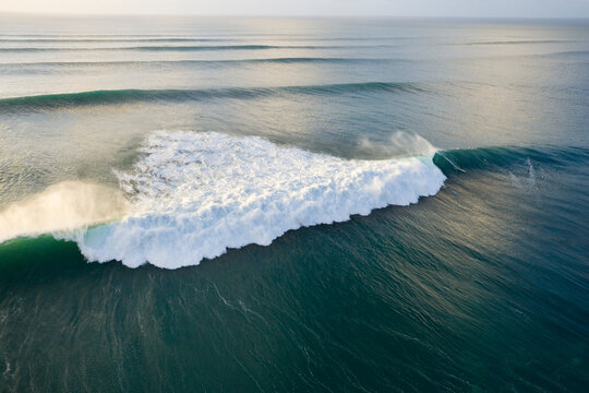 Distant View Of A Surfer Riding A Huge Wave On The North Shore Of Oahu