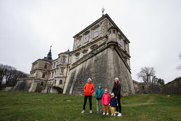 Obraz premium Mother with four kids visit Pidhirtsi Castle, Lviv region, Ukraine. Family tourist.