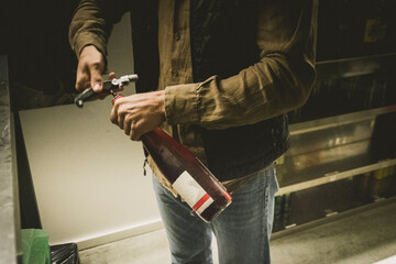 Man opening bottle of wine, Pamplona, Navarre, Spain