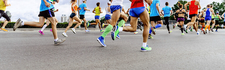Fototapeta na wymiar group runners men and women run marathon race in city