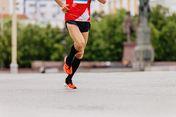 Fototapeta na wymiar man runner in black compression socks running city marathon