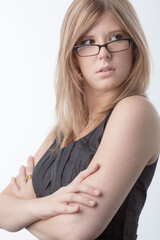 portrait of a young business woman wearing glassess in front of a white background