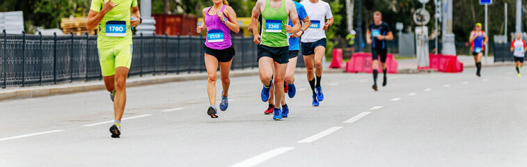 Fototapeta premium group male and female athletes run city marathon race