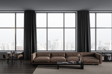 Dark living room interior with eating table and couch, panoramic window