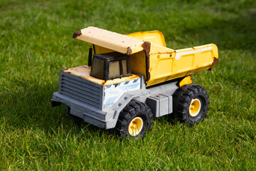 A yellow metal toy construction truck