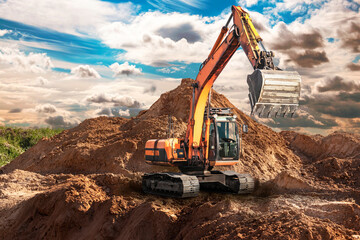 A large yellow crawler excavator moving stone or soil in a quarry. Heavy construction hydraulic...
