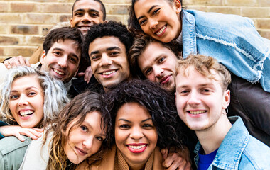 Multiracial friends taking selfie and making funny faces