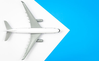 A plane, airplane on a blue background, flat lay, copy space.